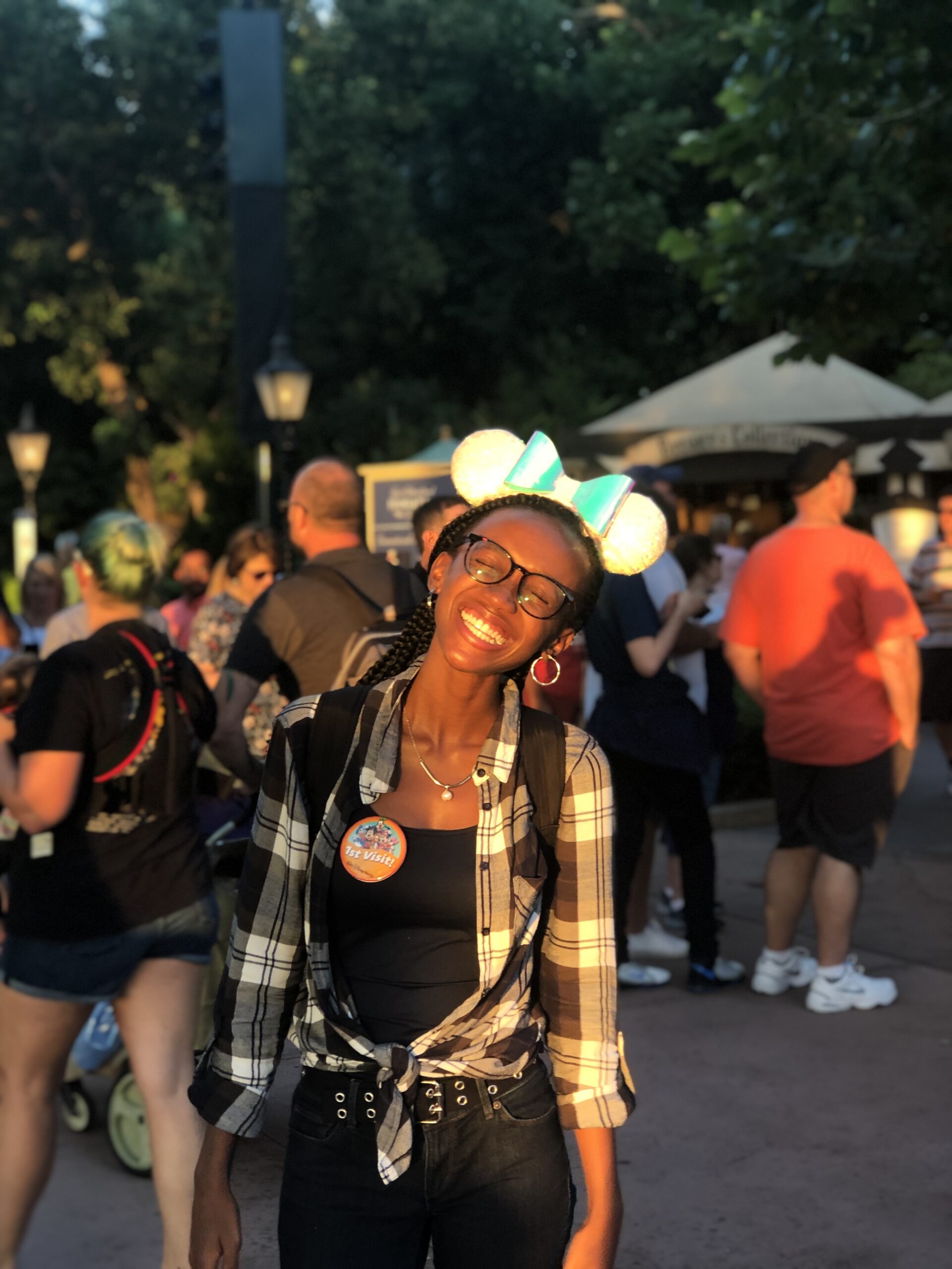 a smiling black girl wears minnie mouse ears in disney world orlando