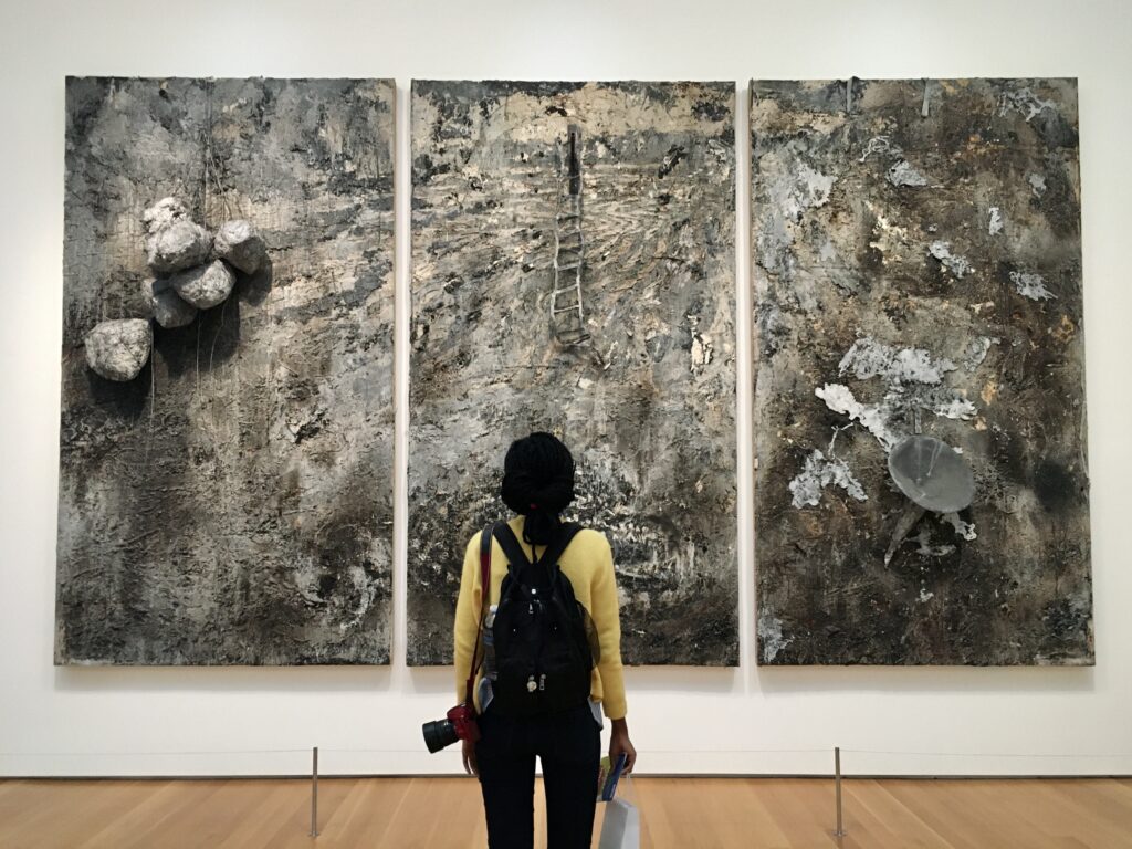 black girl looking at wall painting at the national museum of art in raleigh, nc