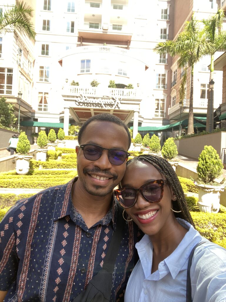 black couple stand outside villa rosa kempinski kenya