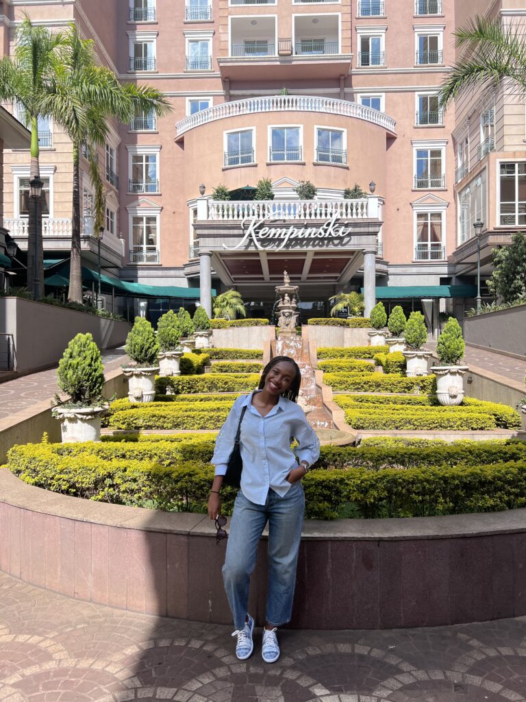 afoma stands in front of villa rosa kempinski nairobi